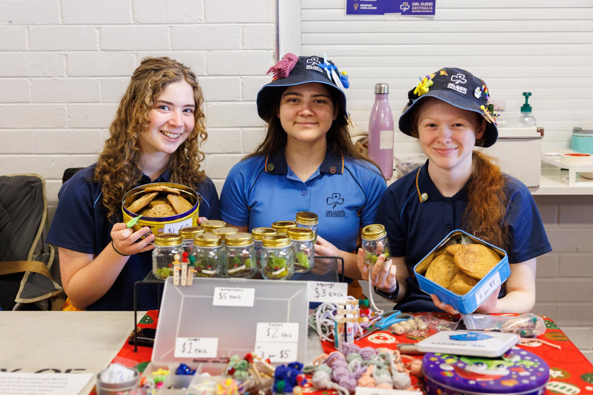 three young girls at market stall